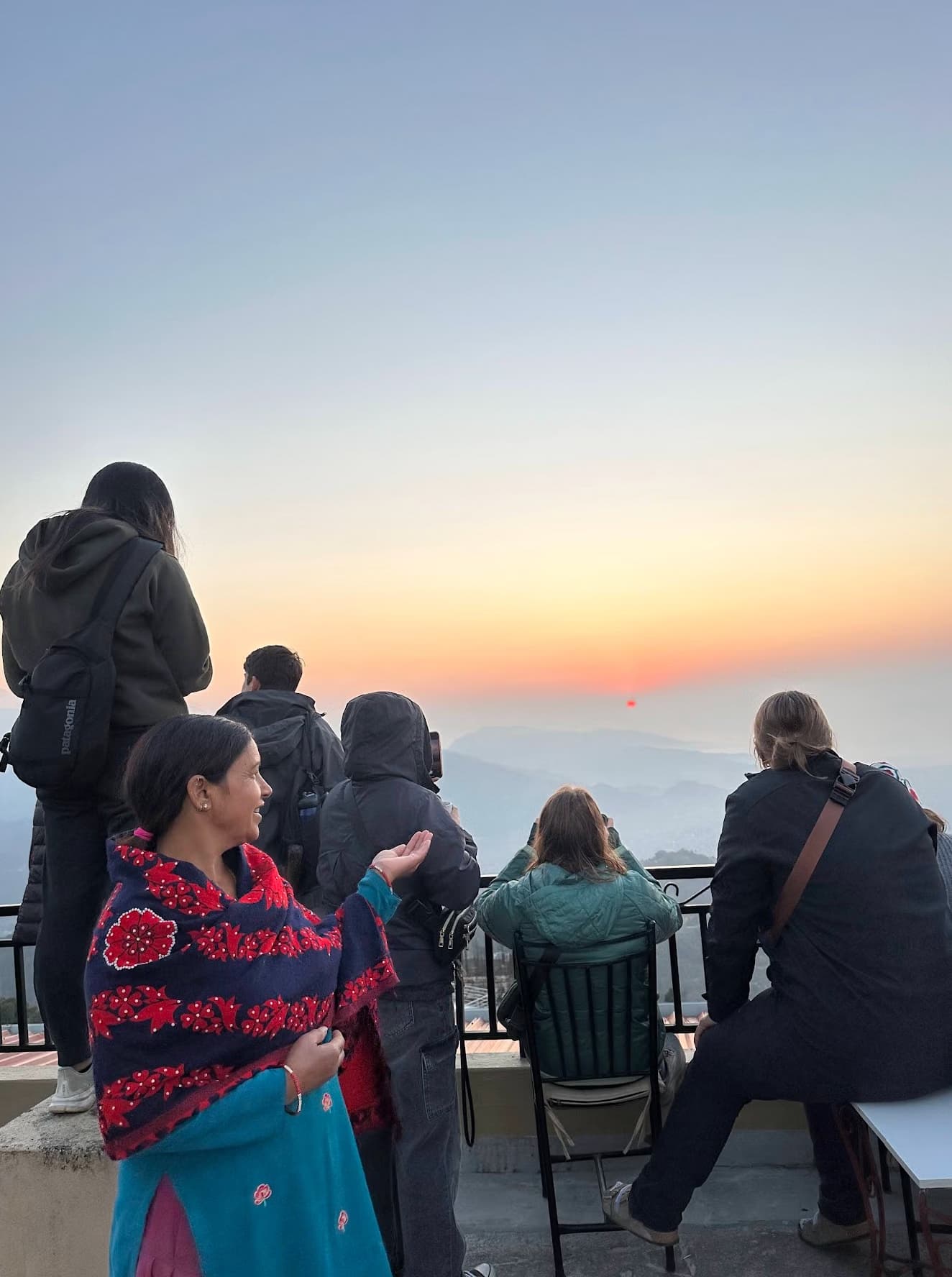 Suman’s mother with Luther College students watching the sunrise from the Superview Lodge terrace, Sarangkot