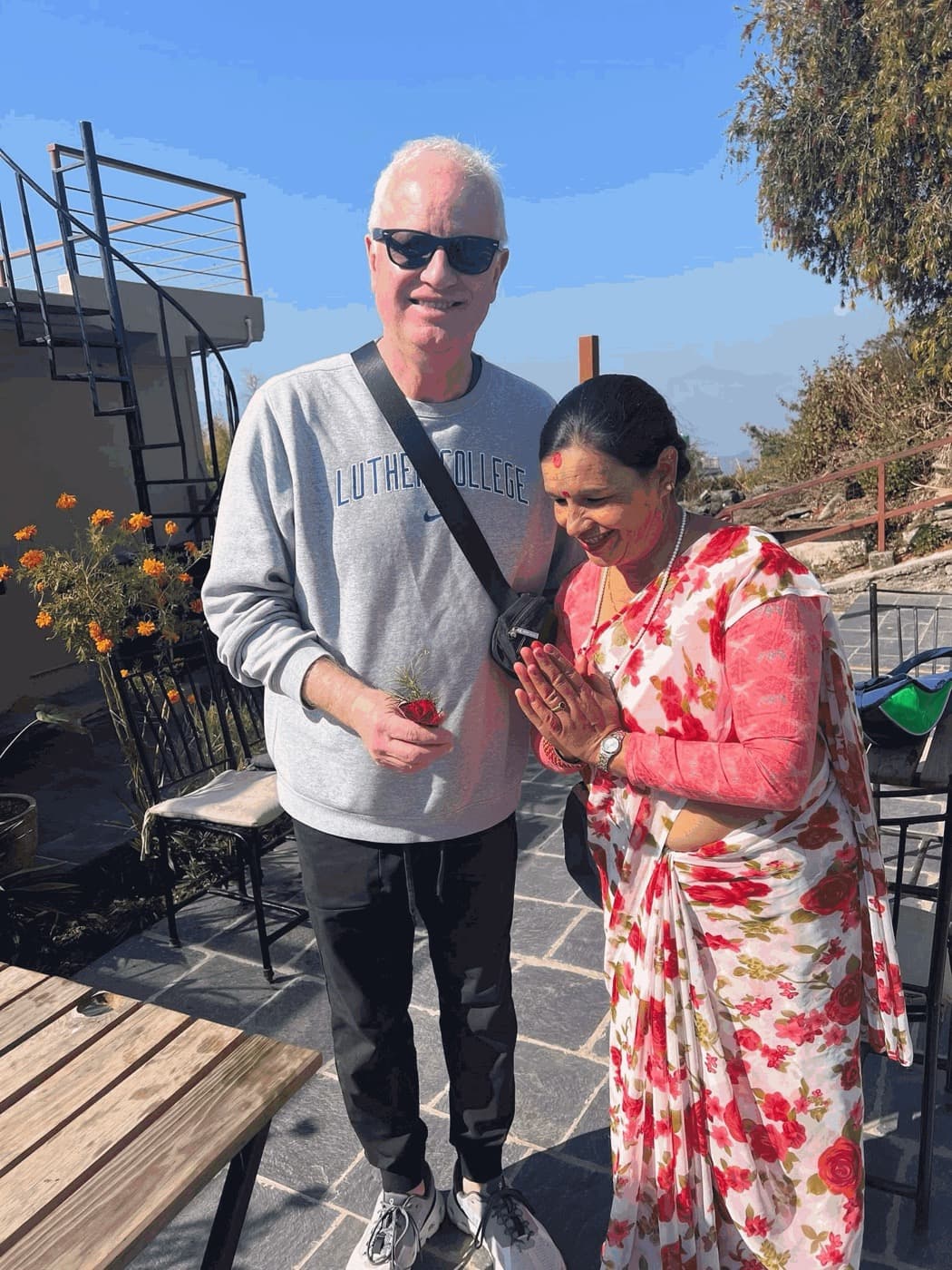 A Luther College faculty member welcomed with a namaste in Sarangkot